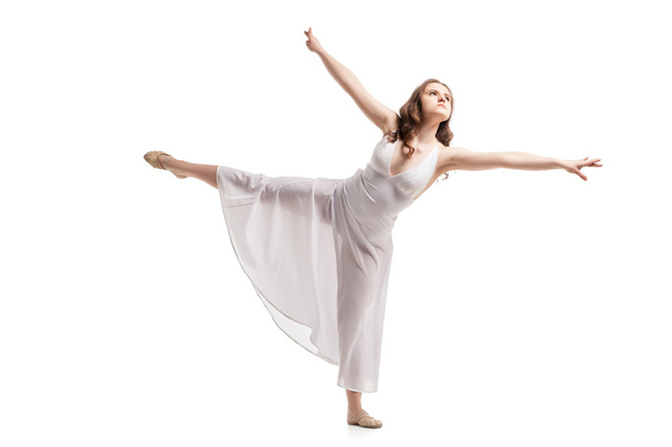 Young woman dancing in dress over white - Photo, image