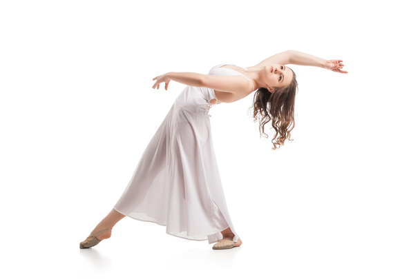 Young woman dancing in dress over white - Foto, imagen