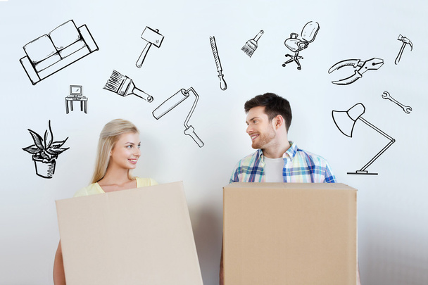 smiling couple with big boxes moving to new home - Zdjęcie, obraz