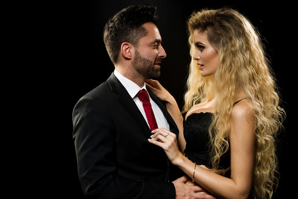 Dark photo of a young couple in sensual lingerie and suit - 写真・画像