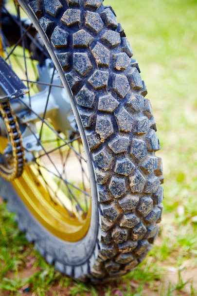 Колесо спортивного мотоцикла близко к траве
 - Фото, изображение