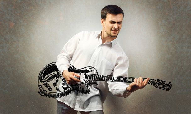 Young man pretending to play guitar - Foto, Imagen