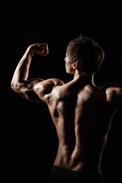 Muscular BACK of male model bodybuilder preparing for fitness tr - Foto, Bild