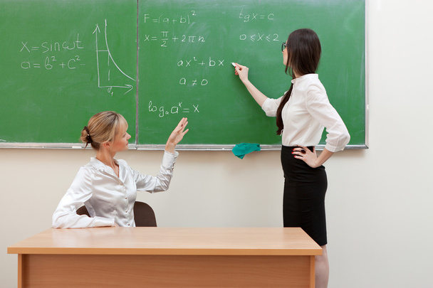 Teacher asks student at blackboard - Photo, Image