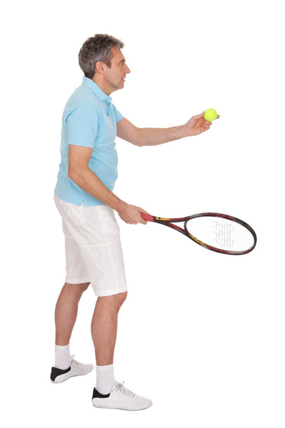 Mature man playing tennis - Foto, imagen