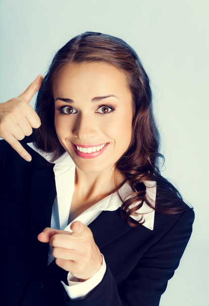 Businesswoman with call me gesture - Photo, Image