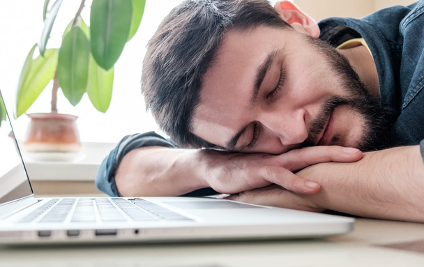 Man sleeping with his laptop - Фото, изображение
