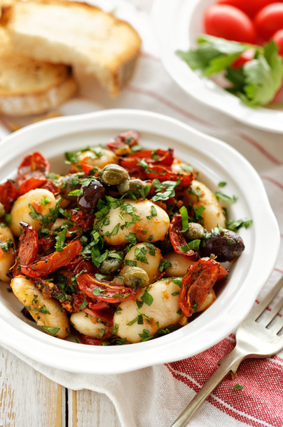 White bean salad with addition of dry tomatoes,  olives, capers and fresh parsley - Photo, Image