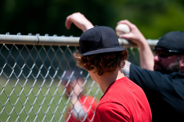 Teenage boy from behind looking through fence. - Photo, Image