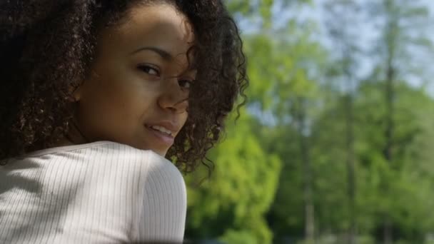 Closeup portrait of a beautiful mixed race woman smiling warmly to a camera. - Materiał filmowy, wideo