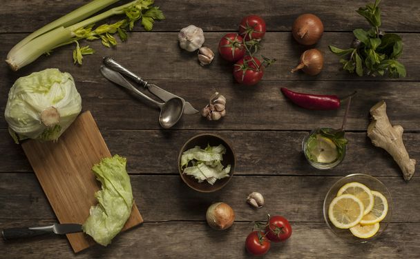 cabbage, tomatoes, garlic and onions on old wooden table - Photo, image