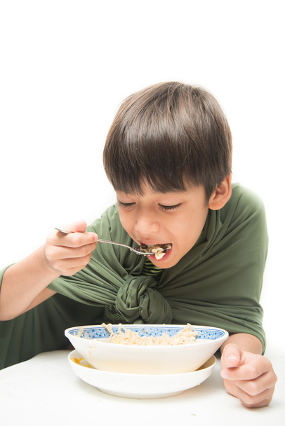 Little boy eating instant noodle on white background - Photo, Image