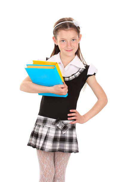 Beautiful little girl in school uniform with books isolated on white - Foto, Imagen