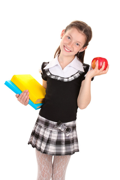 Hermosa niña en uniforme escolar con libros y manzana aislada en blanco
 - Foto, Imagen