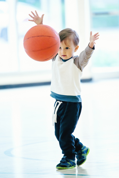 Cute adorable little small white Caucasian child toddler boy playing with ball in gym, having fun, healthy lifestyle childhood concept - Photo, Image