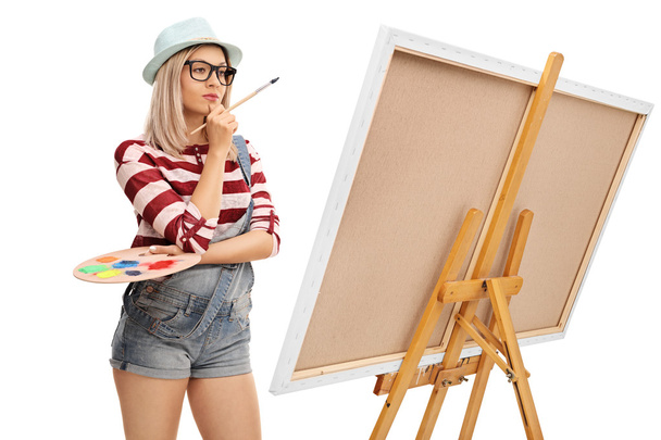 Female artist looking at a painting  - Foto, imagen