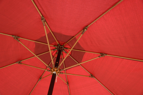 Red Patio umbrella under the sun - Фото, зображення