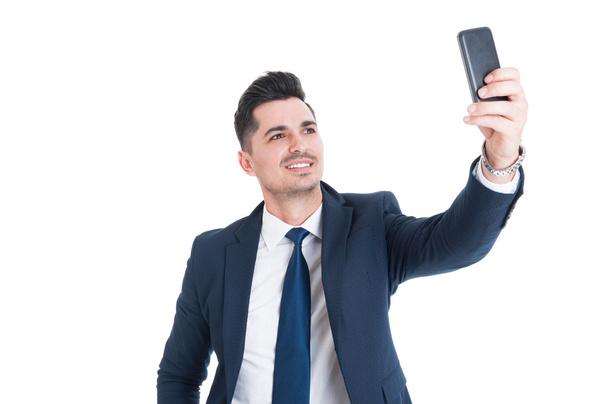 Portrait of young business man taking selfie and smiling - Fotó, kép