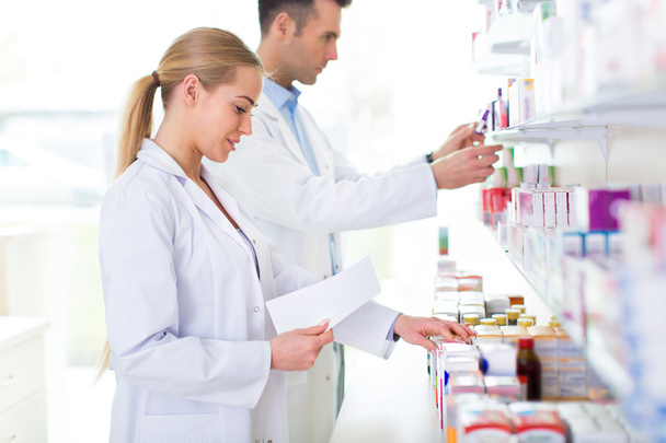 Female and male pharmacists - Фото, зображення