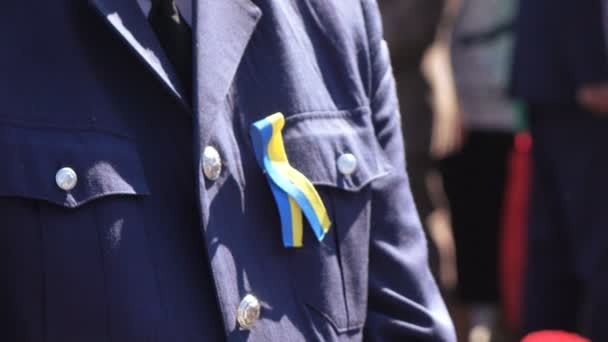 Blue and yellow ribbon on chest police - Felvétel, videó