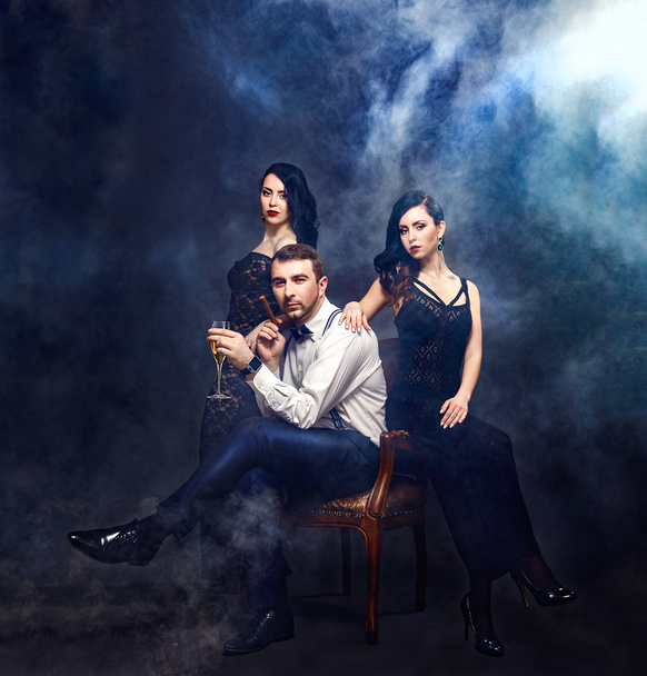 Handsome man surrounded by two beautiful women - Fotografie, Obrázek