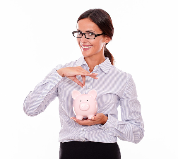 Smiling businesswoman holding piggy bank - Zdjęcie, obraz