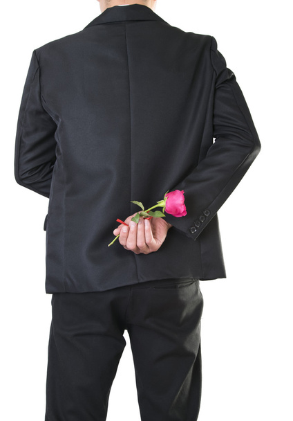hombre de negocios que tiene una flor de rosa aislada de la ruta del recorte - Foto, imagen