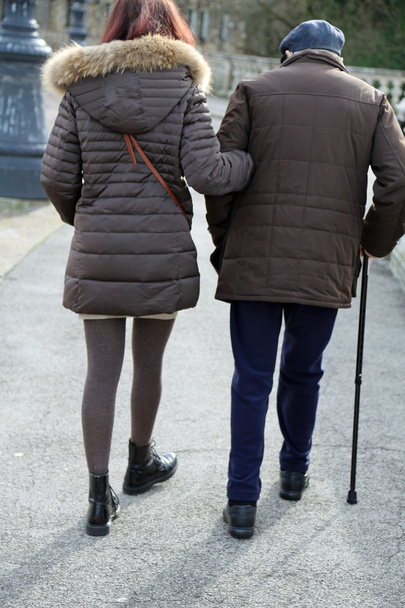 caring daughter walk together to the elderly father walking with - Fotó, kép