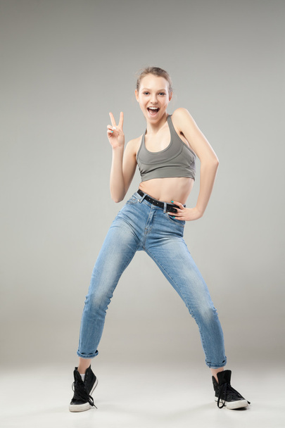 Cheerful young woman with peace sign - Photo, image