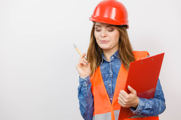 Woman engineer construction builder in helmet. - Фото, зображення