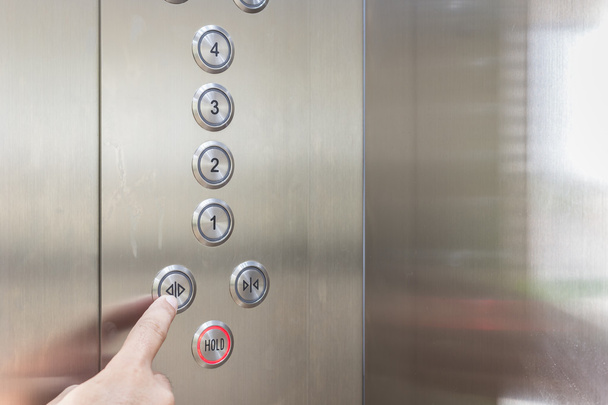 Hand pressing silver elevator button - Valokuva, kuva