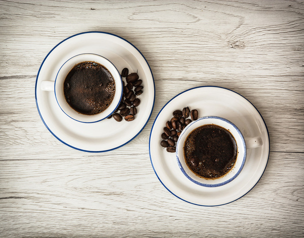 Two ceramic cups of coffee on the wooden background - Photo, Image