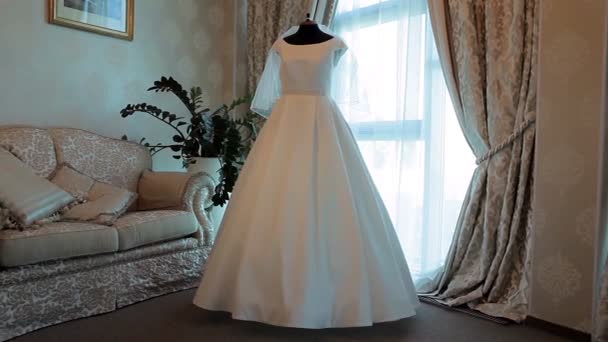 wedding dress hanging on a mannequin in the room - Footage, Video