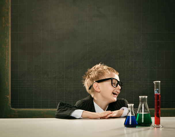 young elegant clever chemistry student or scientist serious pose with blackboard - Foto, Imagem