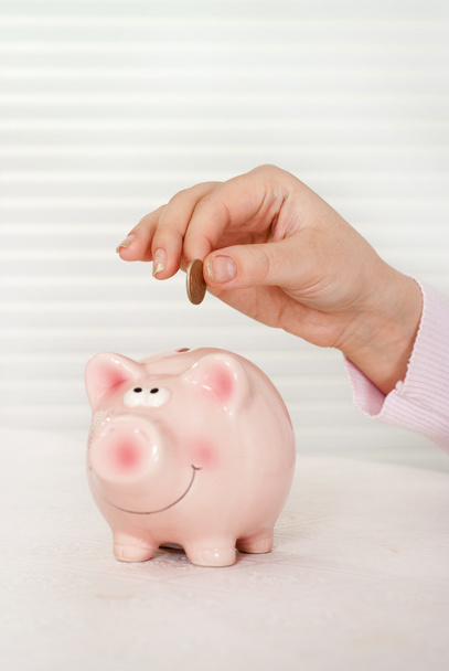 Savings - Piggy bank and hand - Foto, Bild