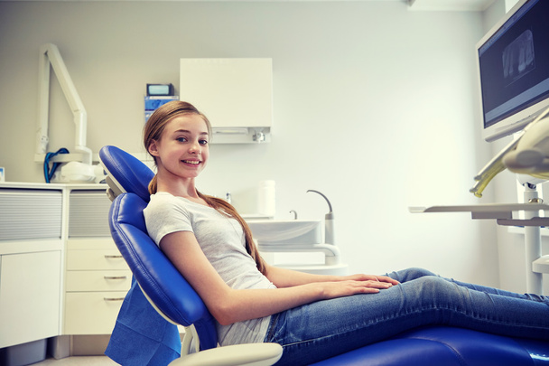 happy patient girl at dental clinic office - 写真・画像