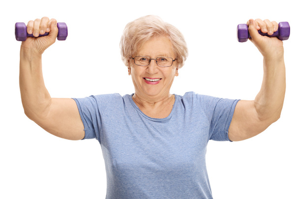 Mature woman exercising with dumbbells  - Fotó, kép