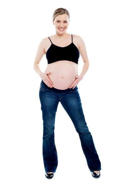 Pregnant woman wearing fashionable outfit - Valokuva, kuva