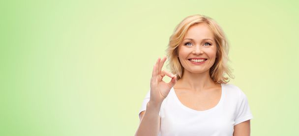 happy woman in white t-shirt showing ok hand sign - Photo, image