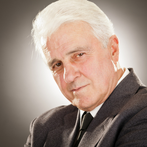 Senior businessman portrait isolated on grey - Foto, Bild