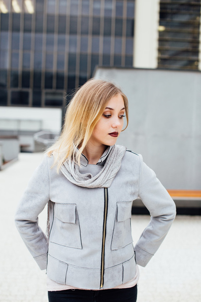 Young woman standing in front of office buildings - Fotografie, Obrázek