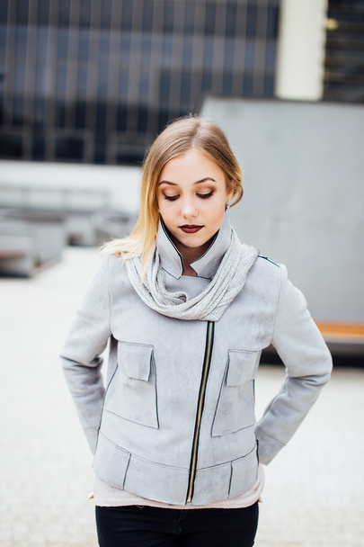 Young woman standing in front of office buildings - Fotografie, Obrázek