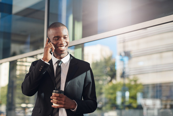 African businessman talking on phone in city - Photo, Image