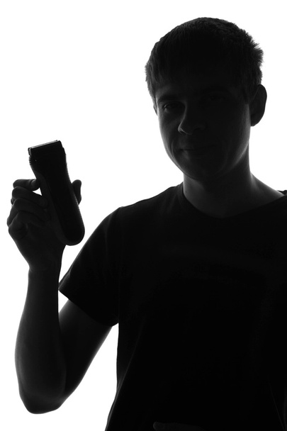young man shaving with electric razor - Zdjęcie, obraz