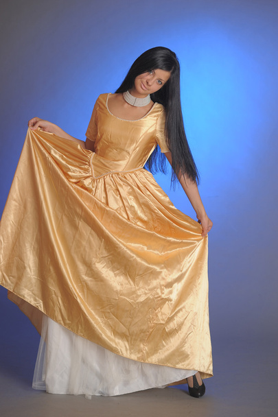 Model in Gold Dress - Фото, зображення