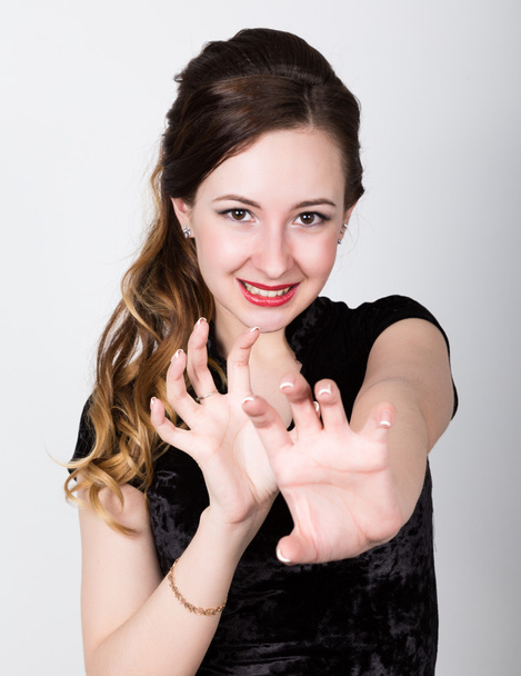 young womans portrait with different happy emotions. she shows hands a cat and growls - 写真・画像