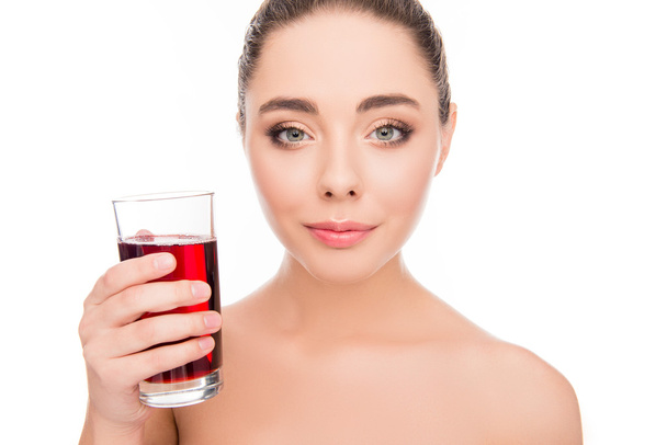 Sensitive pretty happy woman holding glass of cherry juice  - Zdjęcie, obraz