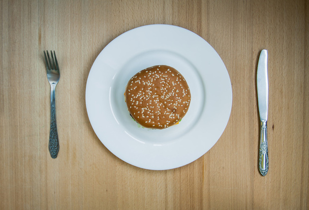 Fast food set big hamburger and french fries on wood background - 写真・画像