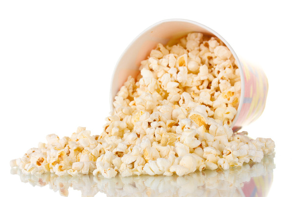 Full bucket of popcorn dropped isolated on white - Foto, afbeelding