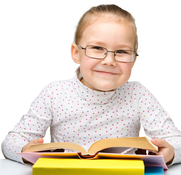 Cute little girl reading book - Фото, изображение